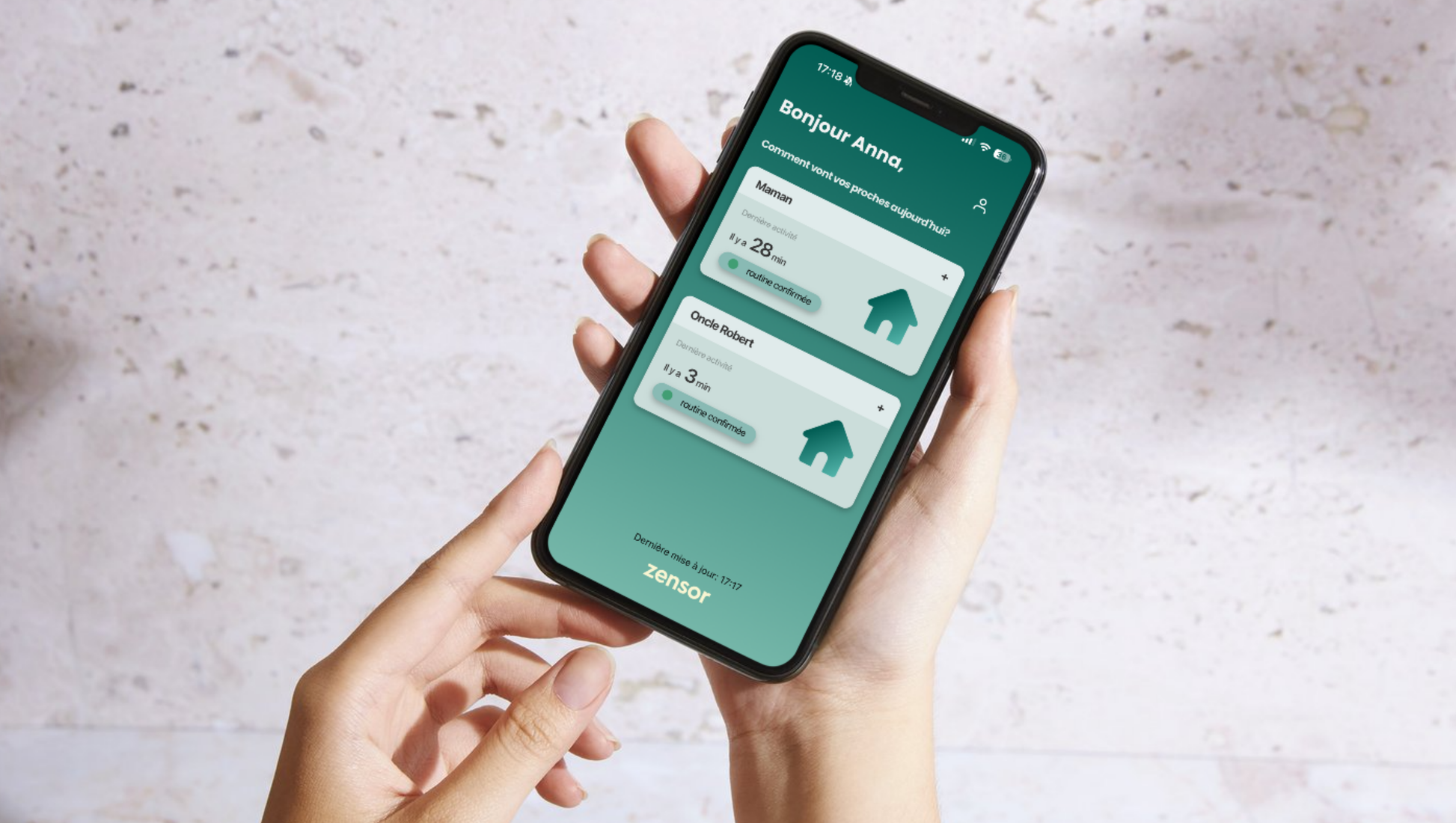 Person holding a smartphone with Zensor app on the screen against a light background